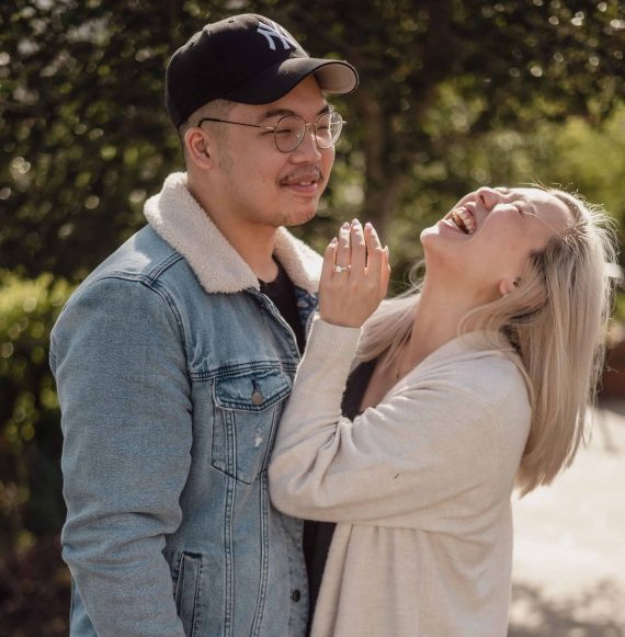 A couple laughing during their engagement session.